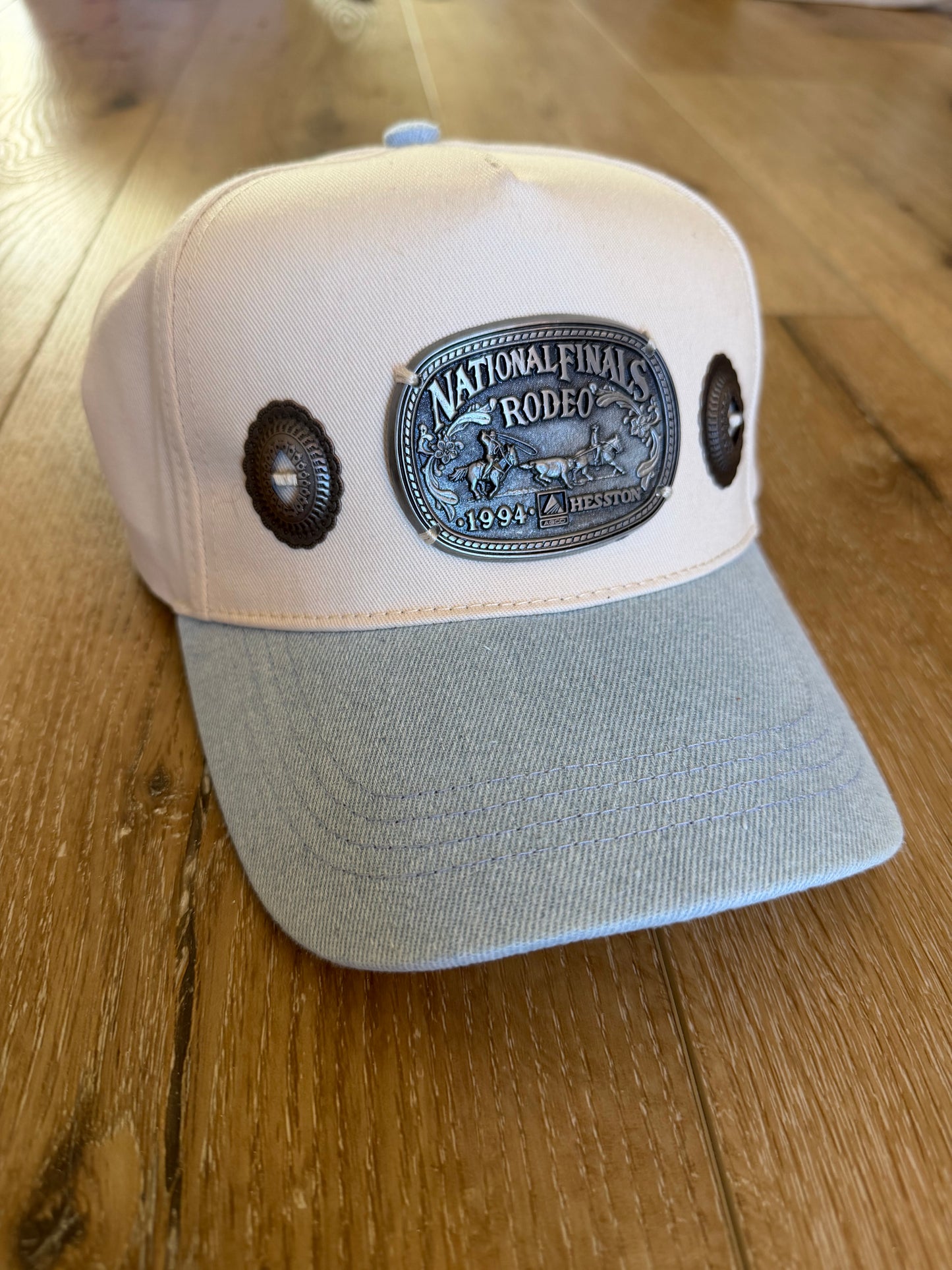 A Concho NFR belt buckle trucker hat
