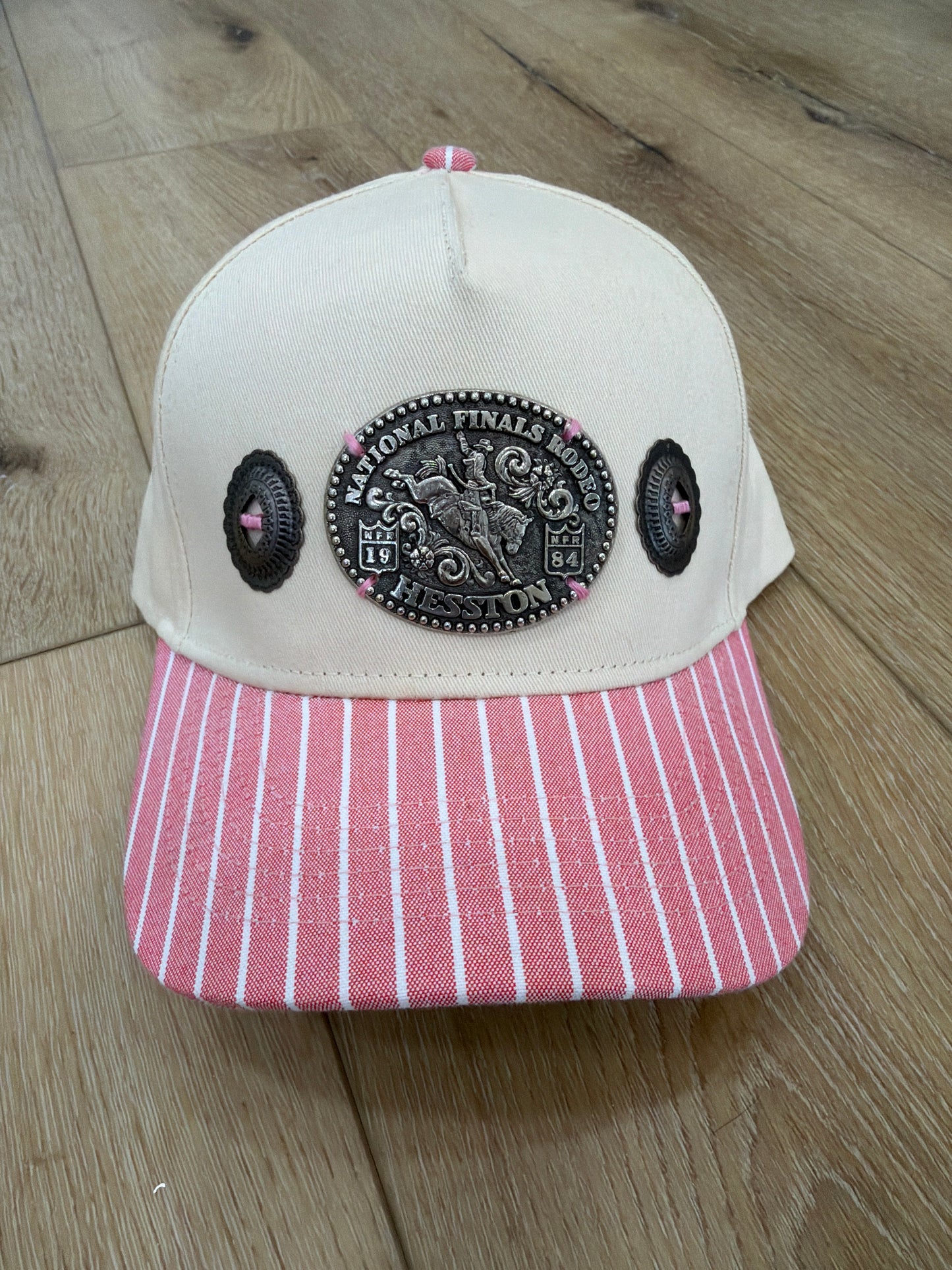 A Concho NFR belt buckle trucker hat