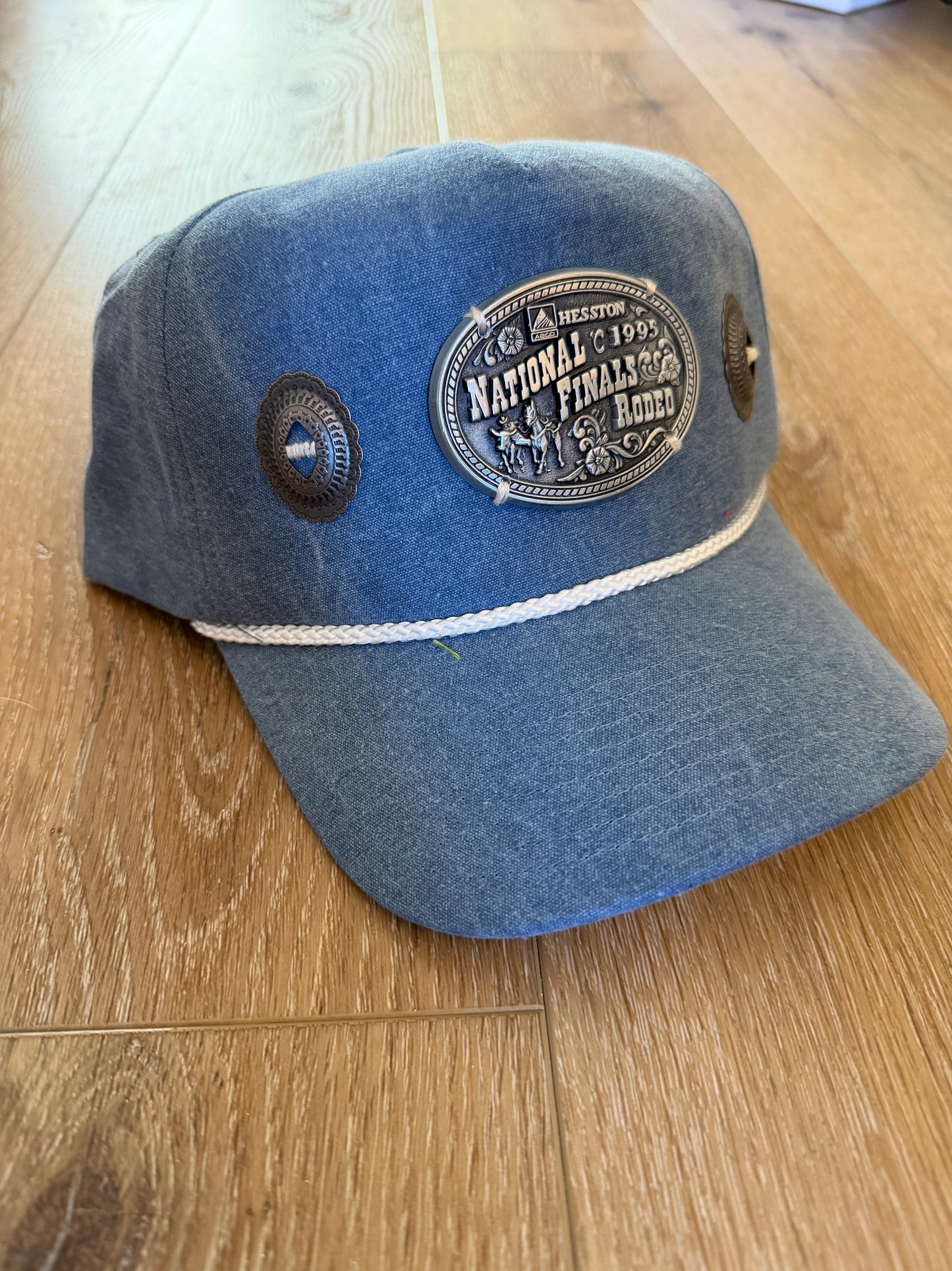 A Concho NFR belt buckle trucker hat