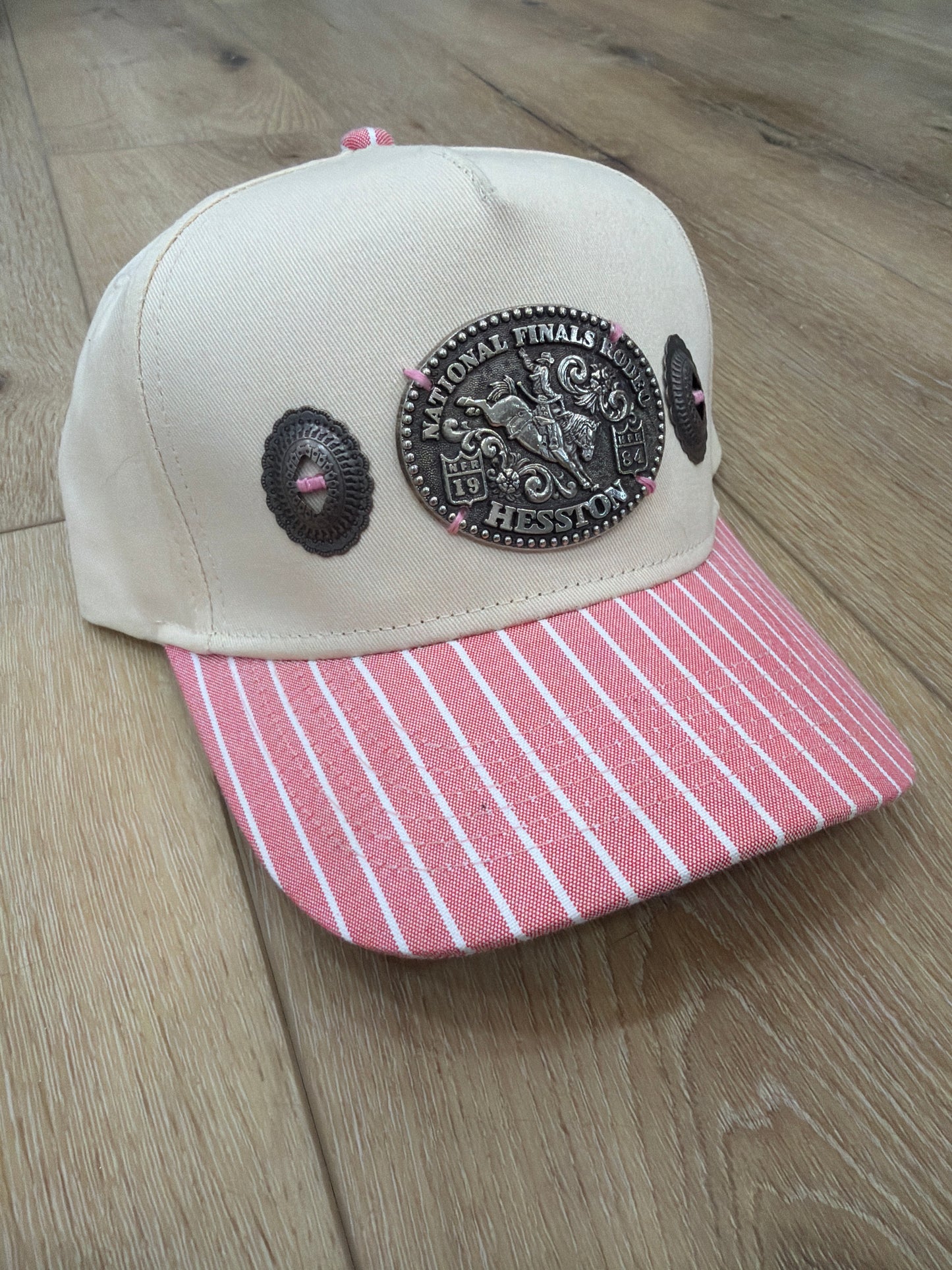 A Concho NFR belt buckle trucker hat